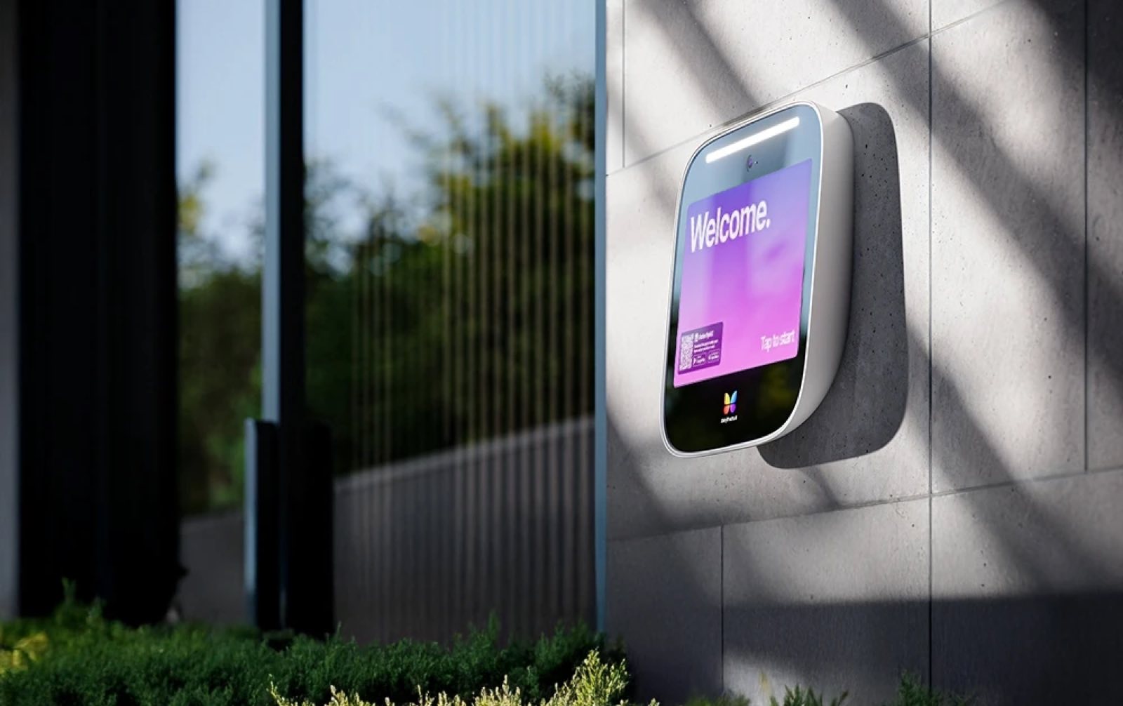 Video intercom panel mounted beside the entrance of a commercial building