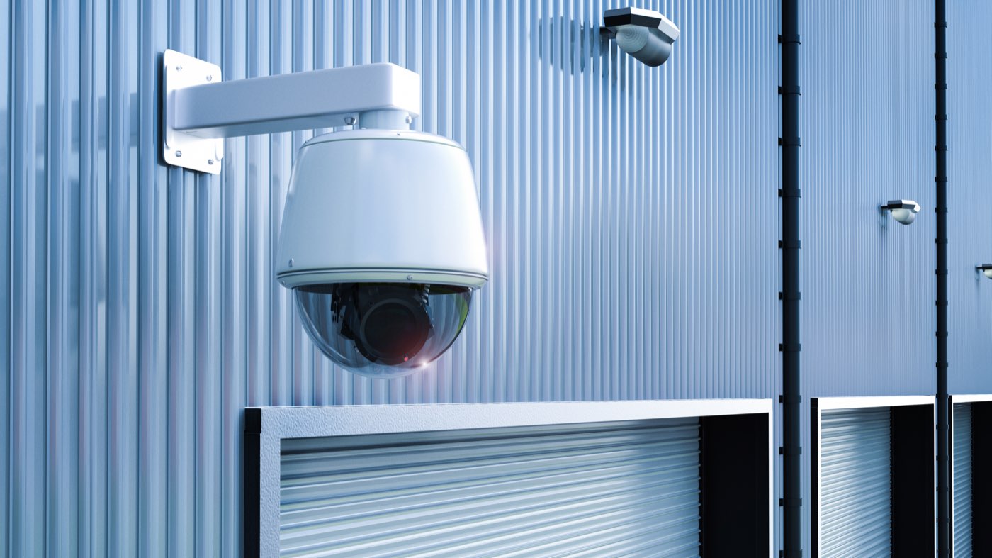 Exterior pan-tilt-zoom dome camera mounted on a commercial building facade